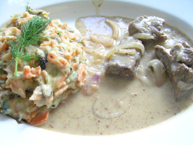 a plate of food with pasta, meat and vegetable soup
