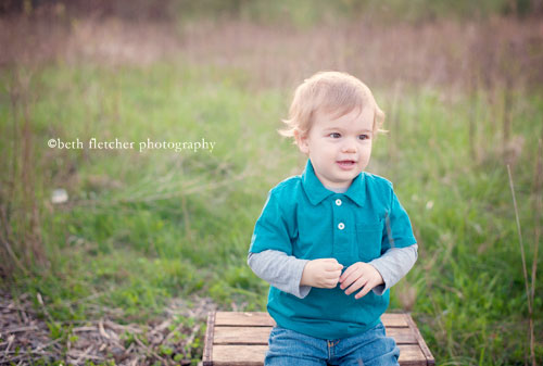 a child is sitting on a bench outside