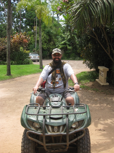 man riding on an off road four wheeler in the park