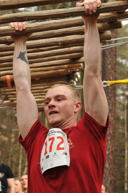 a man holding up a large piece of wood