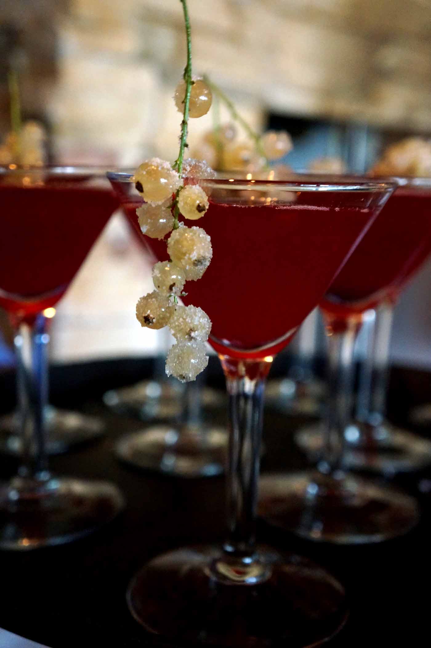 some glasses with drinks are sitting on a table