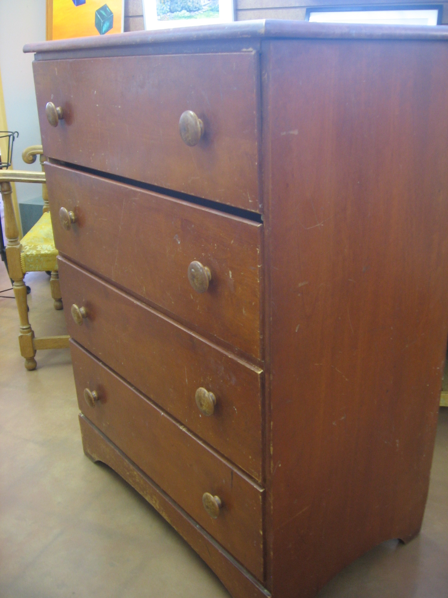 a wooden dresser with five drawers on the bottom