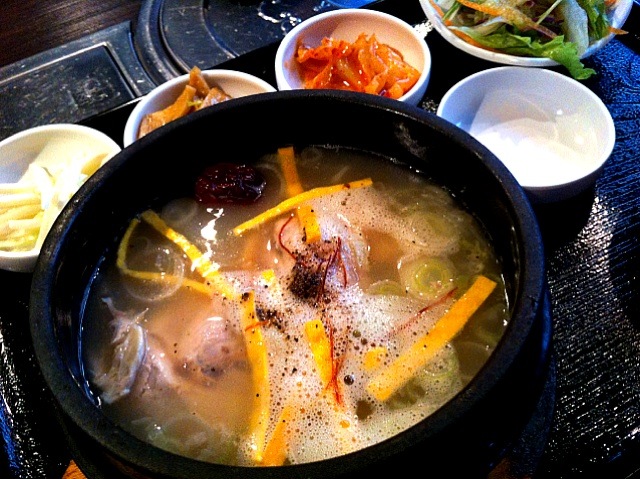 a pot that is full of food with a spoon