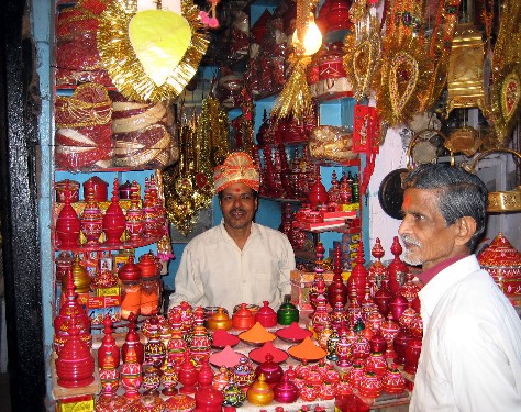 a vendor sells handictures in a brightly decorated shop