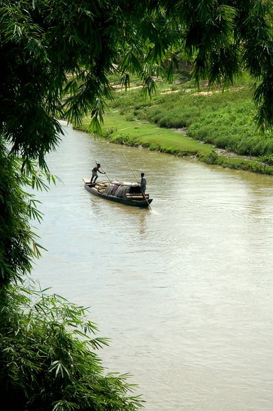 a small boat is floating down a narrow river