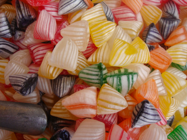 a close up image of several multi colored sweets