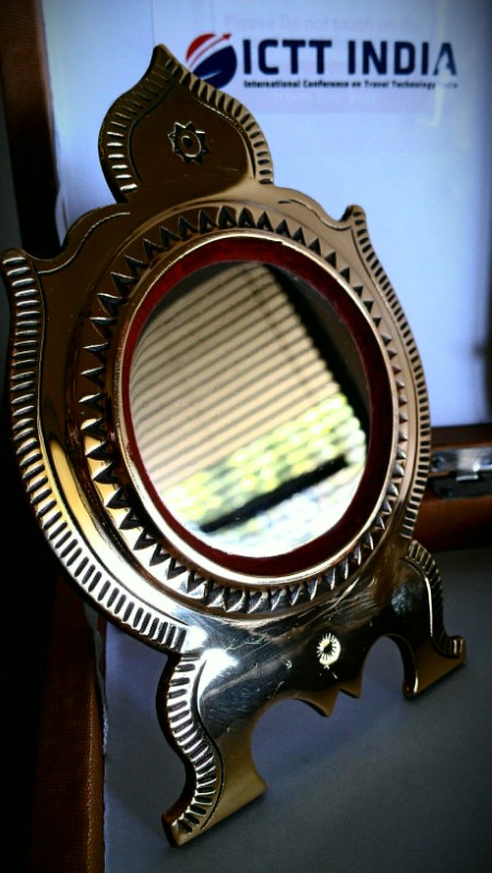 an antique mirror sits in front of the indian sign
