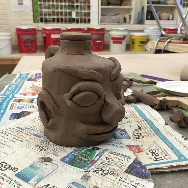 this is a clay clay pot that is on some paper