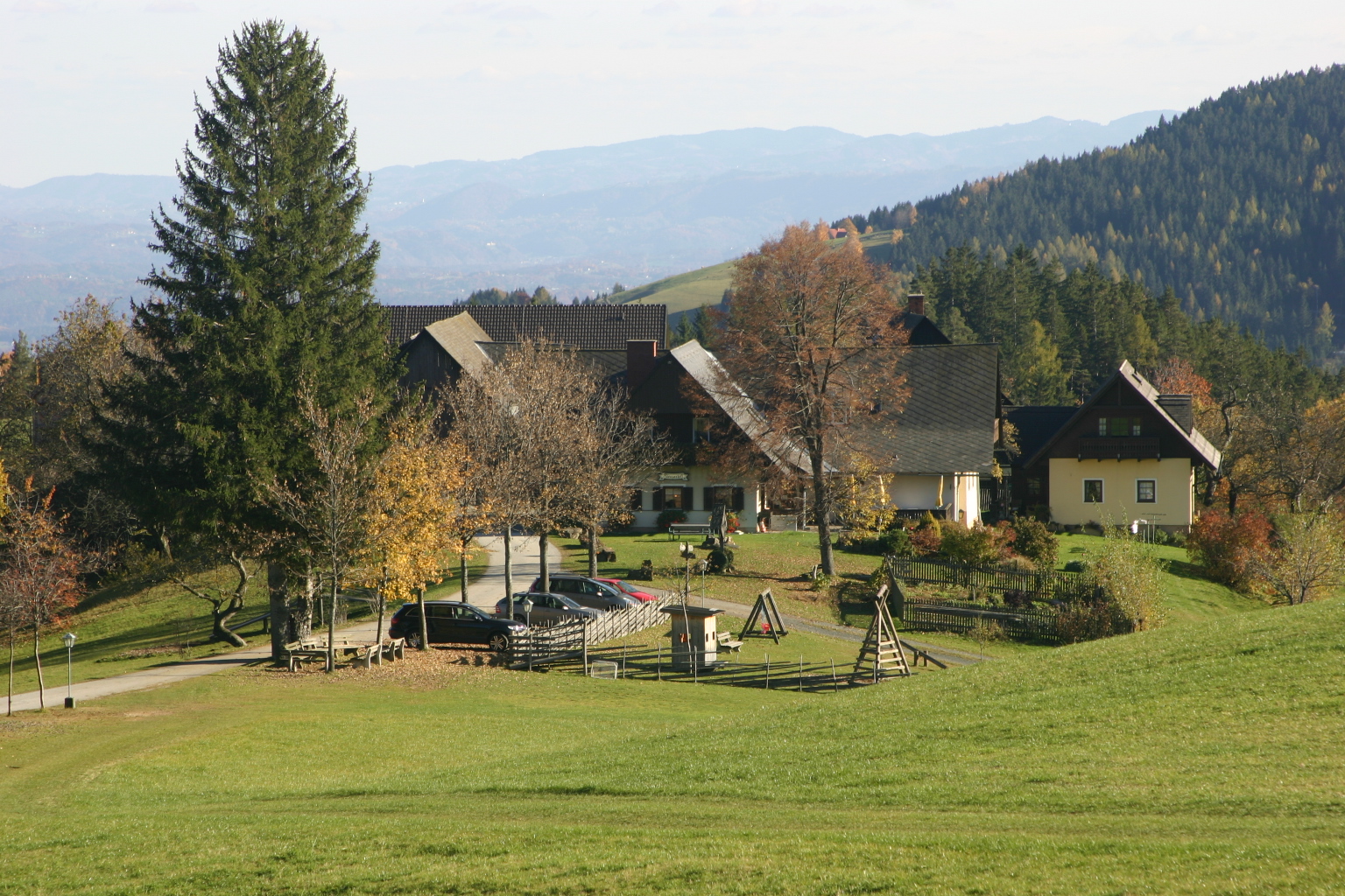 a small house sits on the edge of a hill