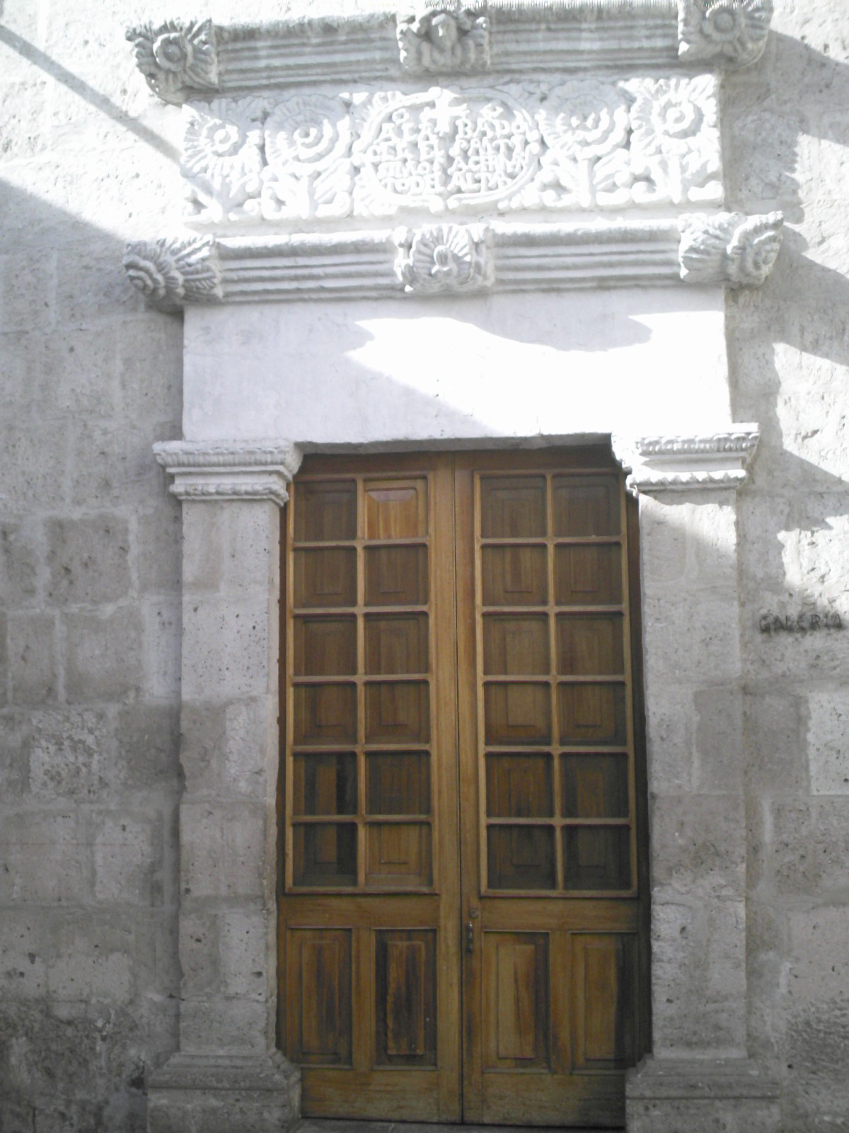 a pair of doors that have been placed in front of an old stone building