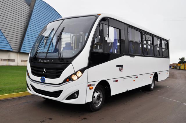 a white city bus parked on a street