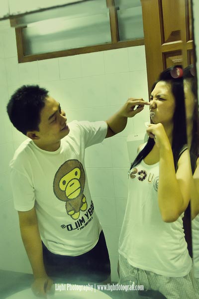 a couple brushing their teeth in a bathroom