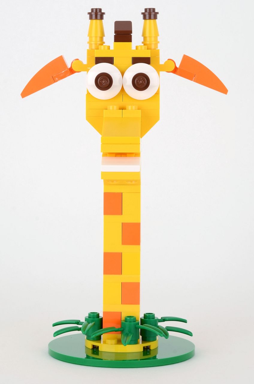 a lego giraffe is on top of a small piece of plastic