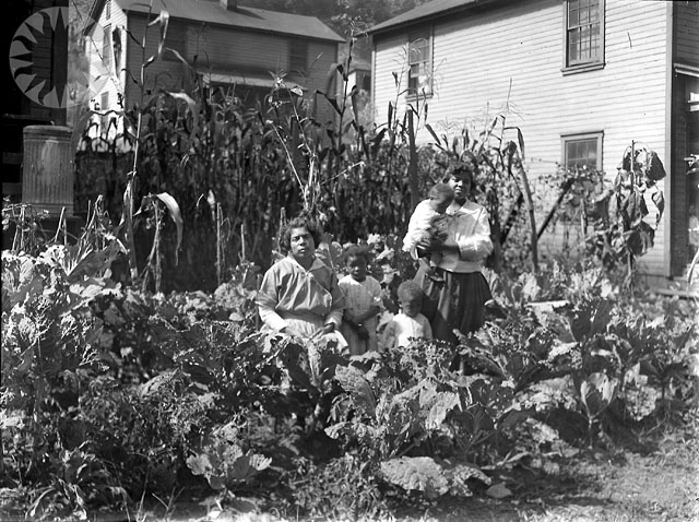 an old po of people sitting in a garden