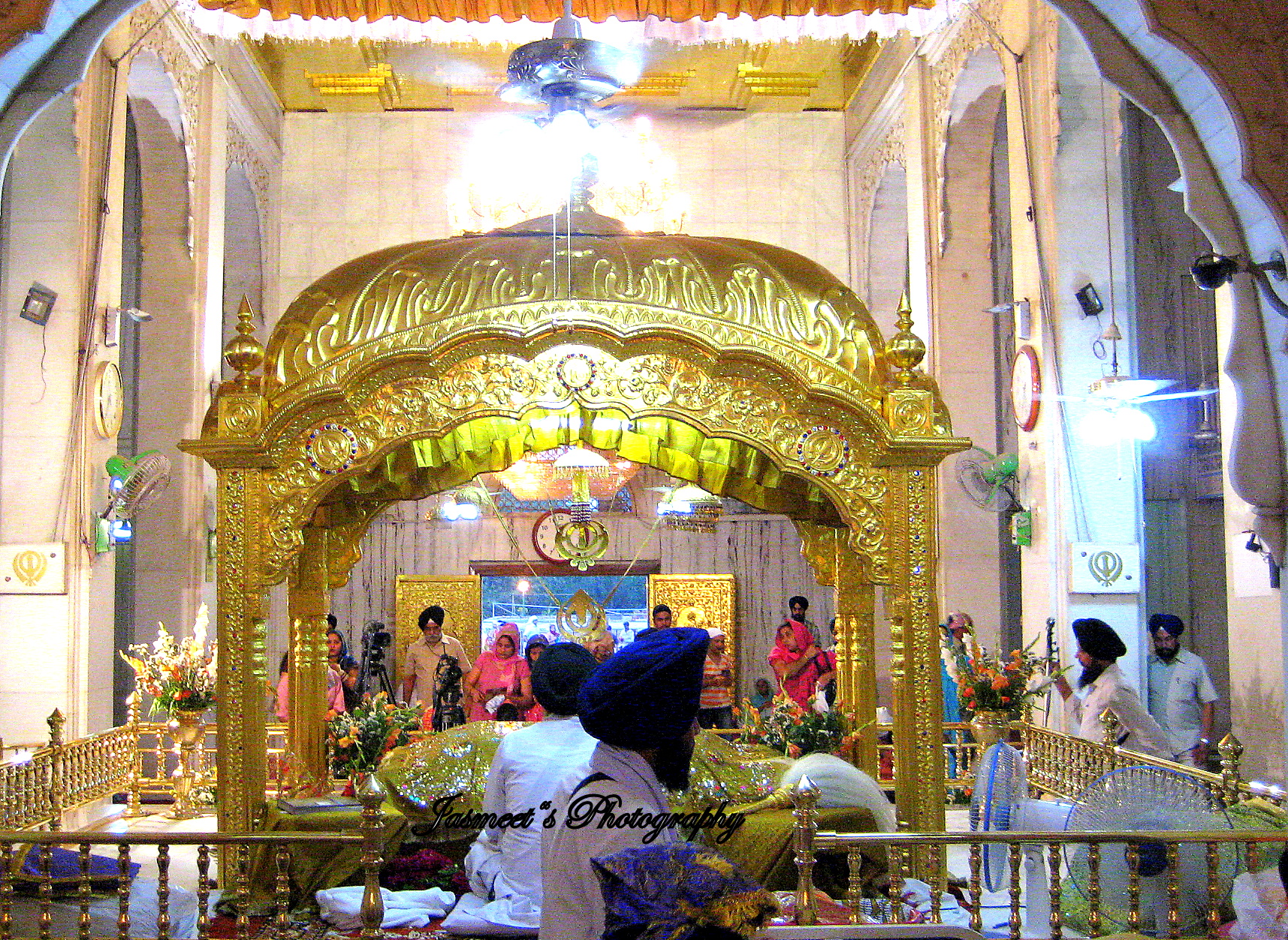 people standing inside a church decorated in gold and white
