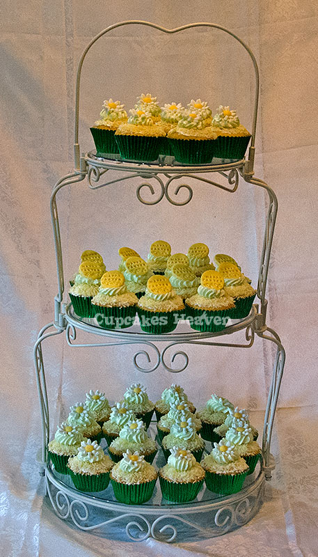 two tiered cake display with frosted cupcakes