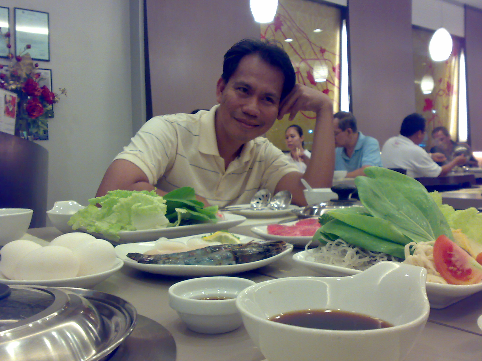 a man is sitting at a table with his food