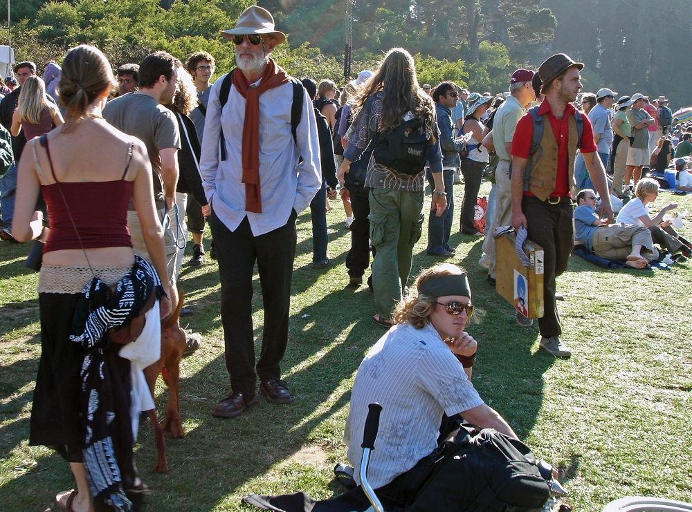 a crowd of people at a music festival in the sun