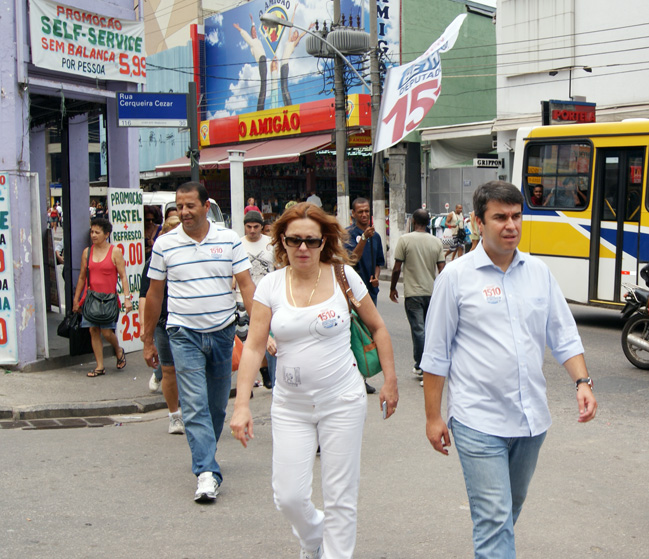 a man and woman walk down a city street