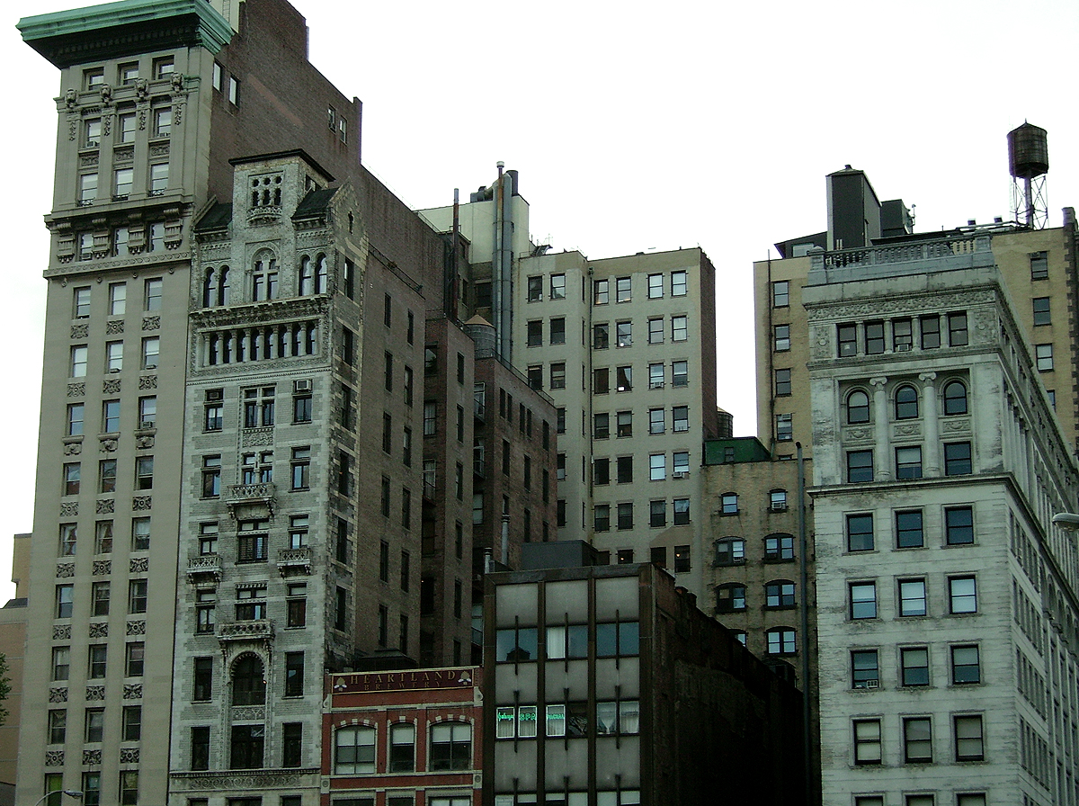 an old row of tall buildings in a big city