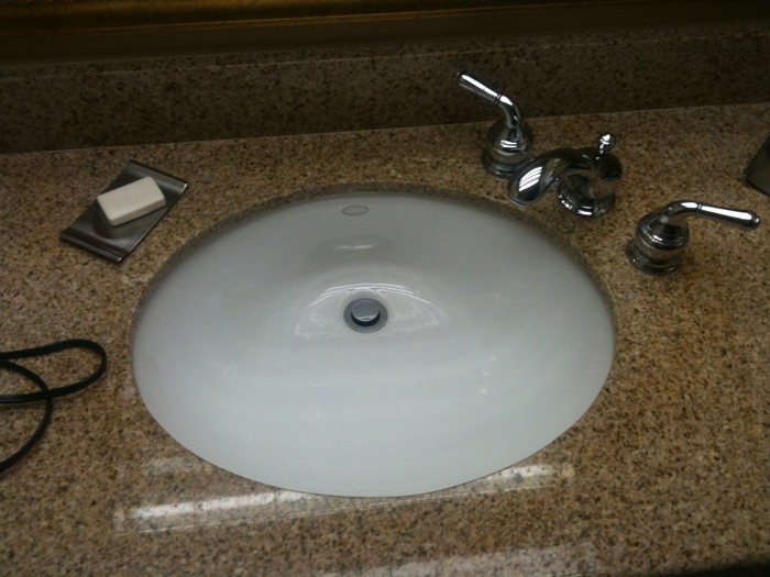 a sink and a hair dryer on top of the sink
