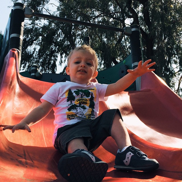  sitting on slide at a playground