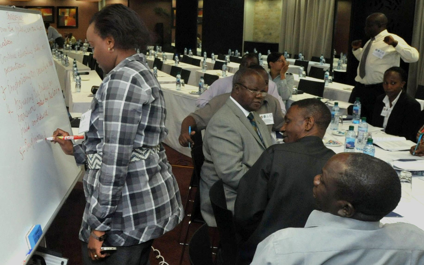 a group of people at tables in a room