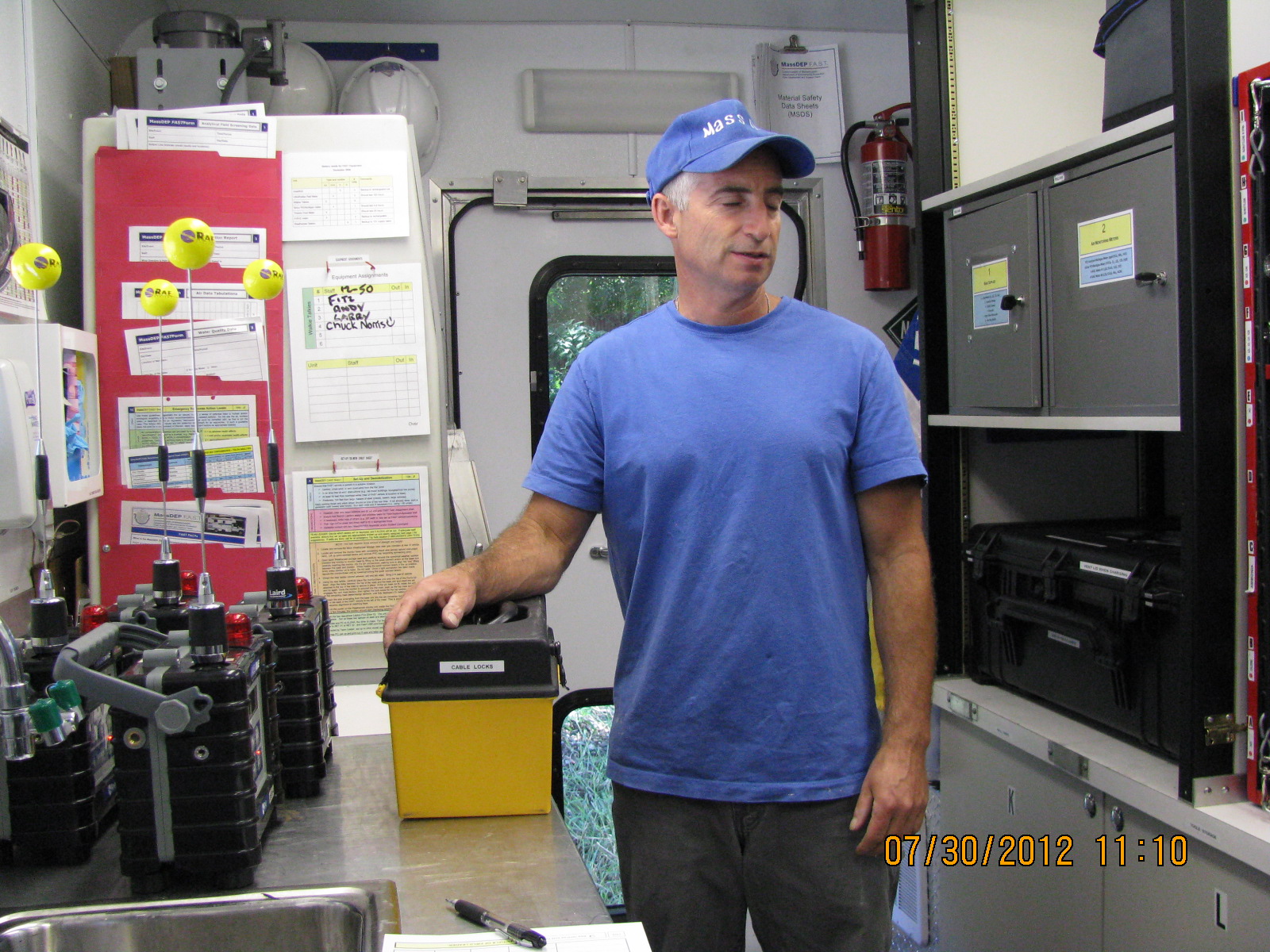 a man holding a tool box while standing in a garage