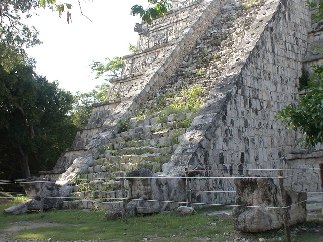 a very large pyramid by some rocks in a field
