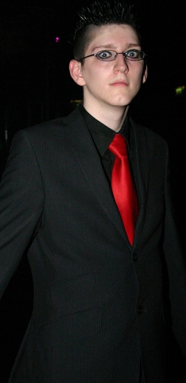 a man in a suit and red tie