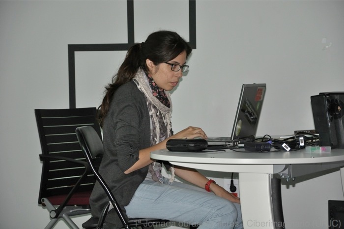 a woman at a table working on a computer
