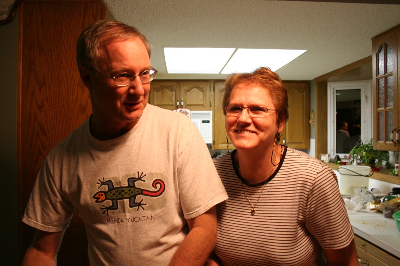 man standing next to a woman in a kitchen