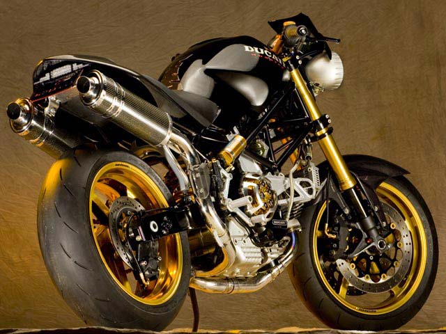 a black and gold colored motorcycle on a brown background
