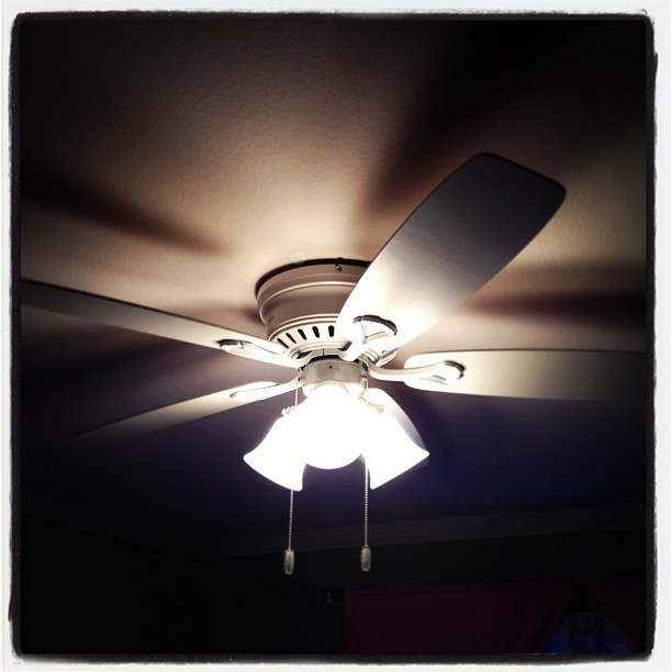 a ceiling fan with three lights attached to it