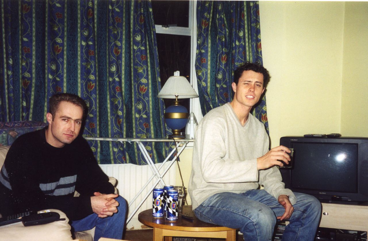 two men sit in front of a television