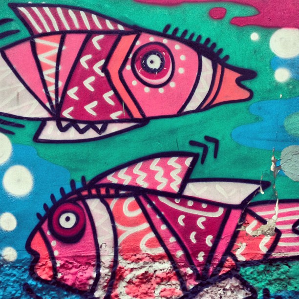 colorful artwork on a building wall depicting fish