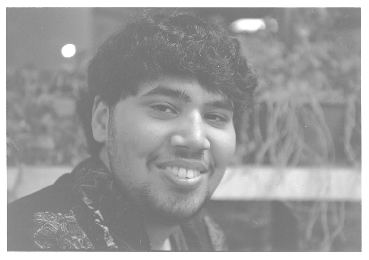 a black and white pograph of a young man smiling