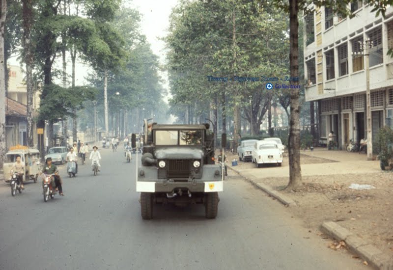 an army jeep is driving on a quiet city street