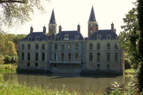 a large house next to the water with lots of windows