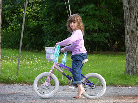 a  riding her bike in a park