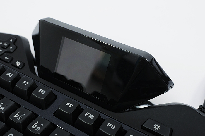 two electronic gadgets are placed on top of the keyboard