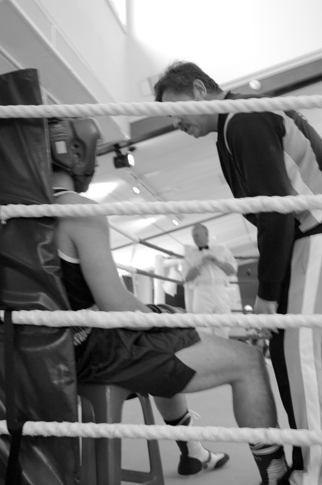 two men are sitting in an airport boxing ring