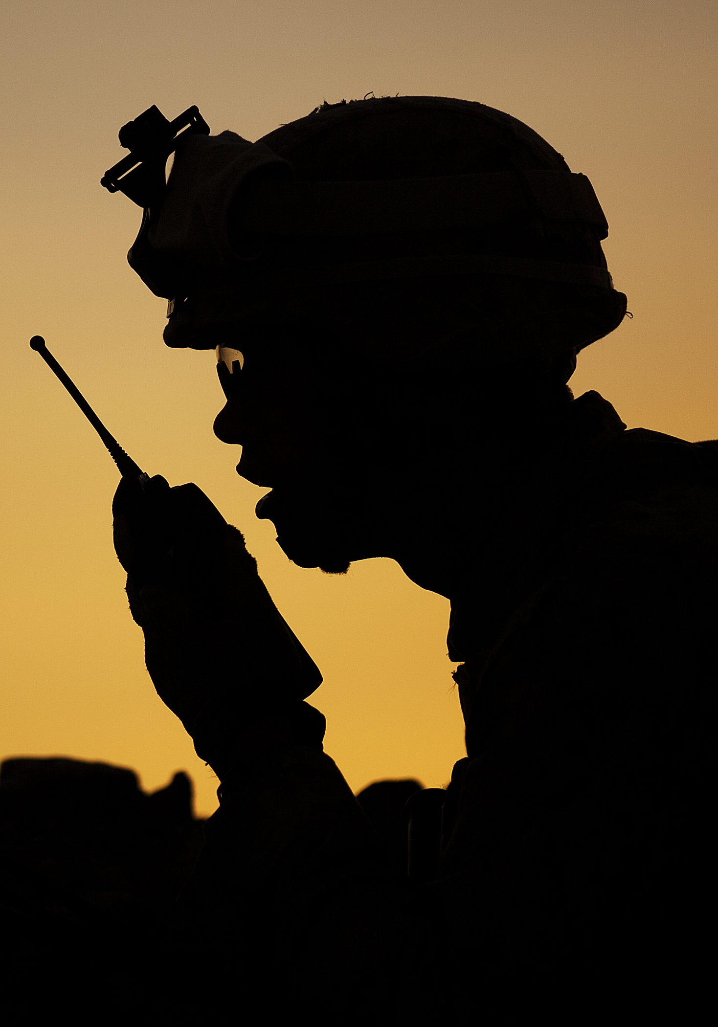 a man looking at a cell phone near the sky