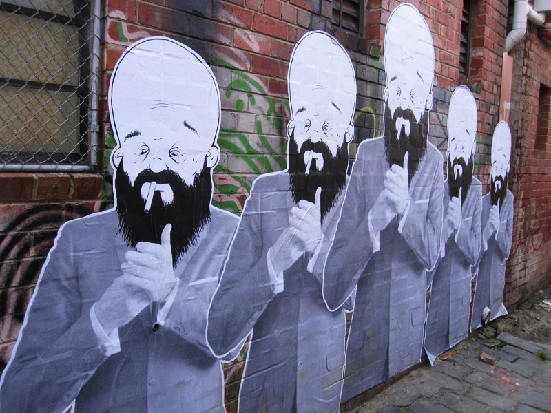 three wall paintings of men with long hair and beards