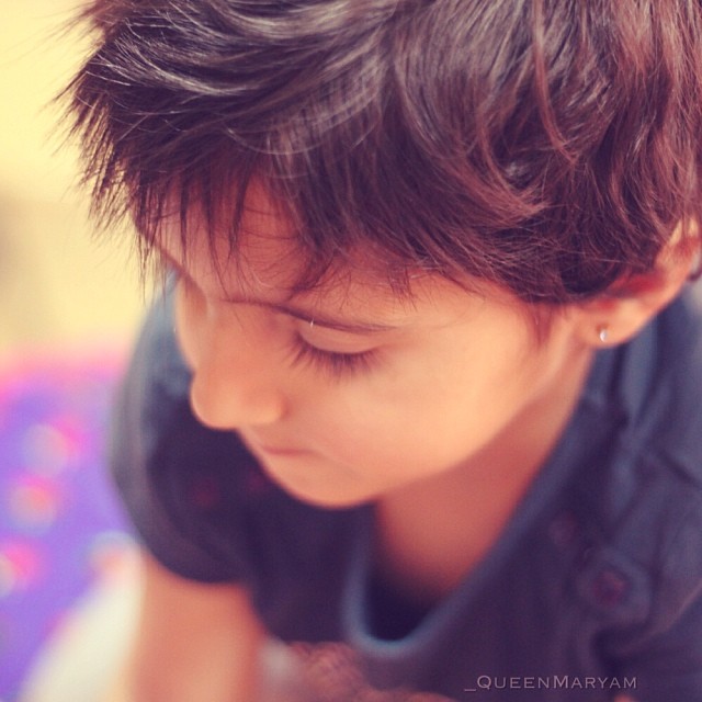 a close up of a child's head with short hair