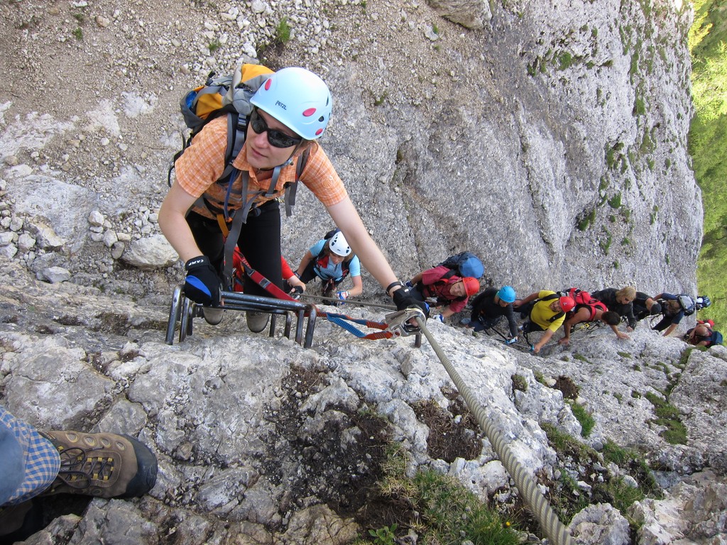 climbers climb up and down the side of the mountain