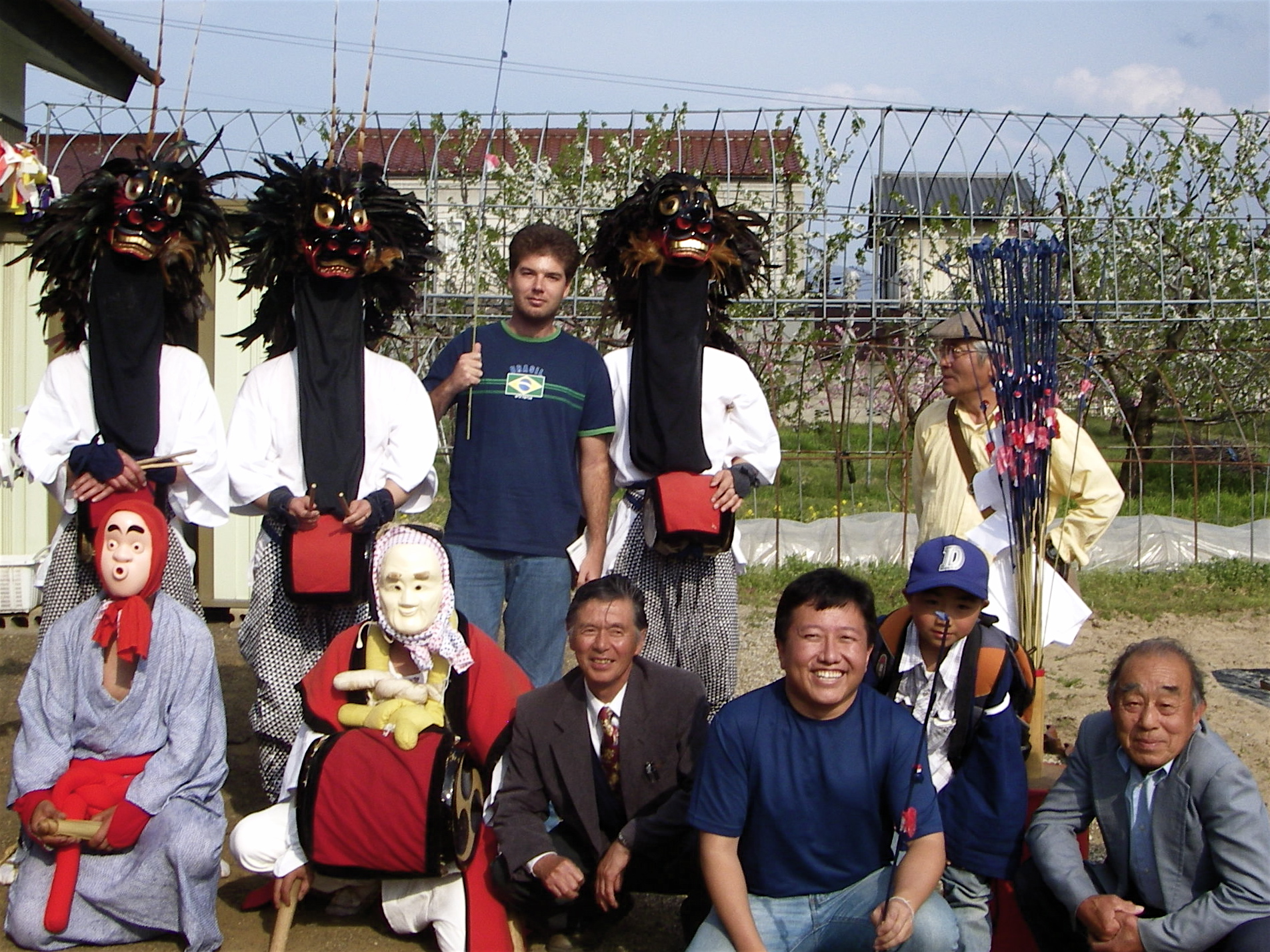 many people wearing masks pose for a picture