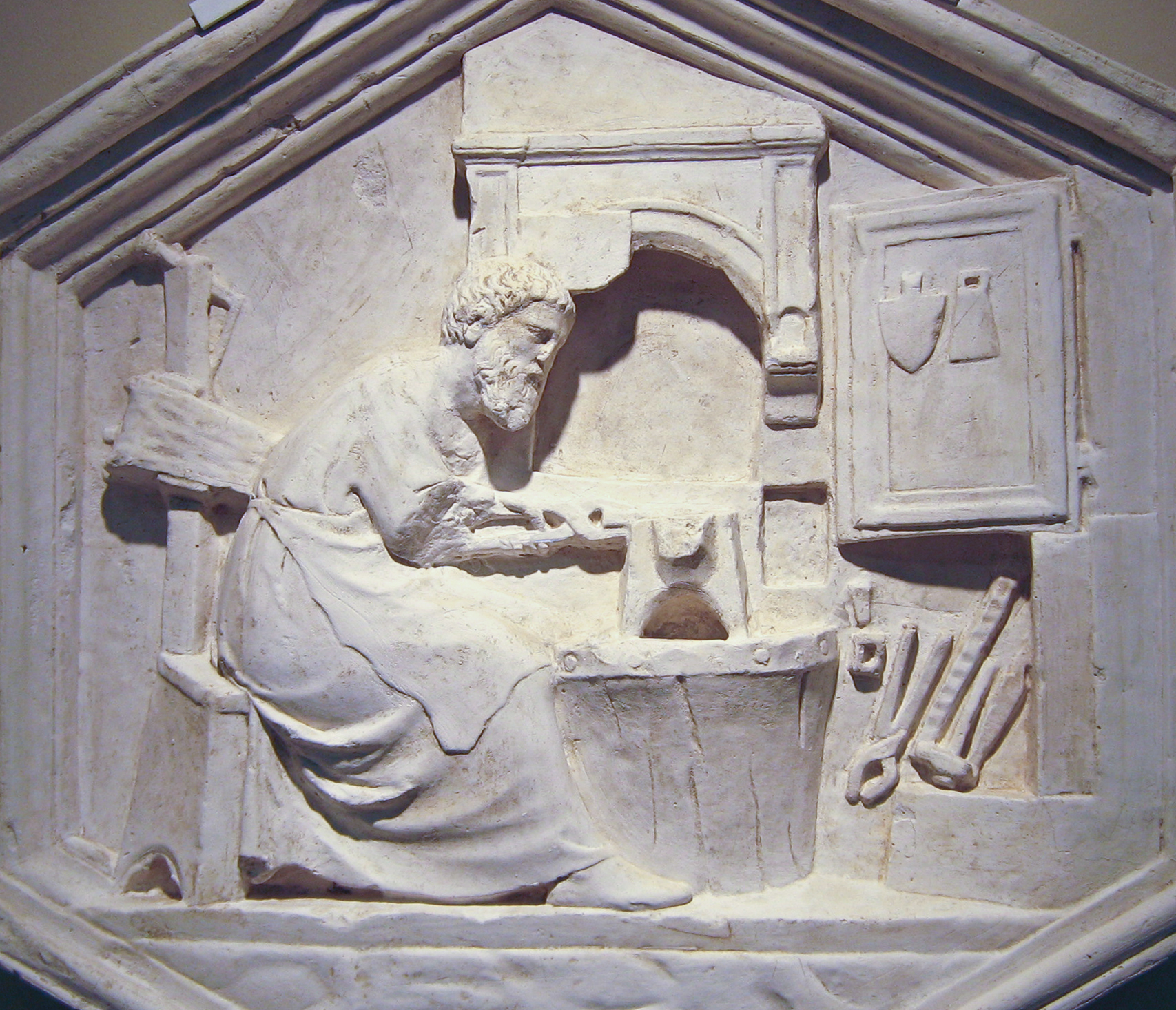 a sculpture of a woman cooking some food