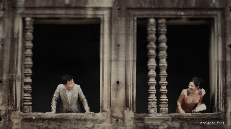 a couple sits in a window and watches the scenery