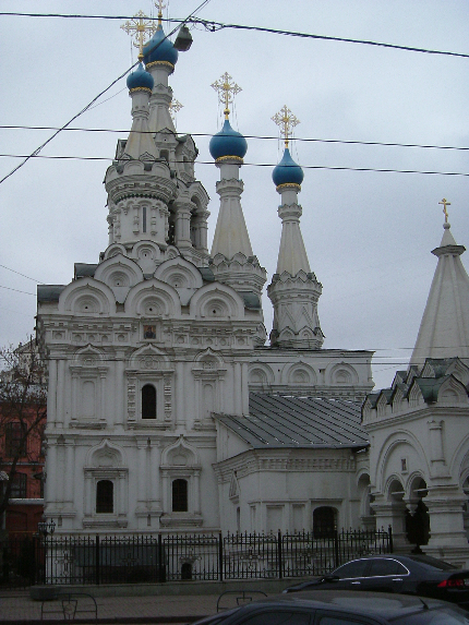 a very large and white building with some blue crosses
